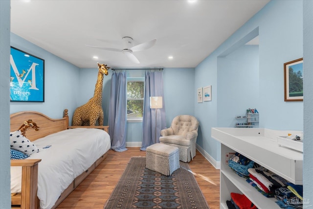 bedroom with hardwood / wood-style floors and ceiling fan