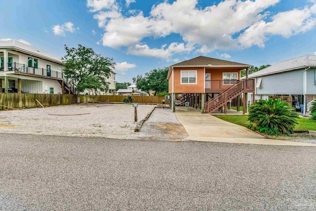 5473 Pensacola Ave, Orange Beach, AL 36561 - beach home featuring stairway, concrete driveway, a porch, and a carport