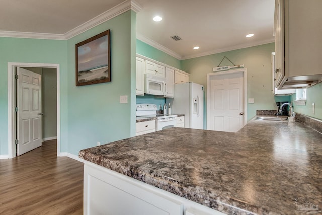 5473 Pensacola Ave, Orange Beach, AL 36561 - kitchen with white appliances, a sink, dark countertops, white cabinetry, and ornamental molding