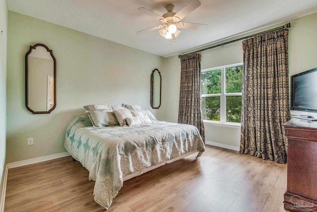 5473 Pensacola Ave, Orange Beach, AL 36561 - bedroom with baseboards, wood finished floors, and ceiling fan