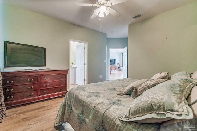 5473 Pensacola Ave, Orange Beach, AL 36561 - bedroom with light wood finished floors, connected bathroom, and a ceiling fan
