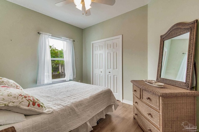 5473 Pensacola Ave, Orange Beach, AL 36561 - bedroom with wood finished floors, a closet, a ceiling fan, and baseboards