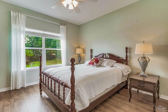 5473 Pensacola Ave, Orange Beach, AL 36561 - bedroom featuring wood finished floors, baseboards, and a ceiling fan