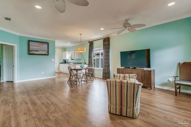 5473 Pensacola Ave, Orange Beach, AL 36561 - living area featuring ceiling fan, ornamental molding, baseboards, light wood-type flooring, and recessed lighting