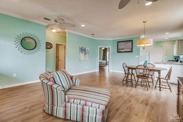 5473 Pensacola Ave, Orange Beach, AL 36561 - living room featuring ceiling fan, crown molding, light wood finished floors, baseboards, and recessed lighting
