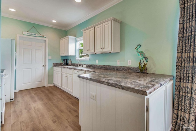 5473 Pensacola Ave, Orange Beach, AL 36561 - kitchen with a sink, crown molding, dark countertops, light wood-style floors, and recessed lighting