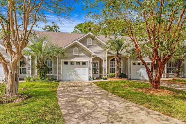 view of front facade with a front yard and a garage