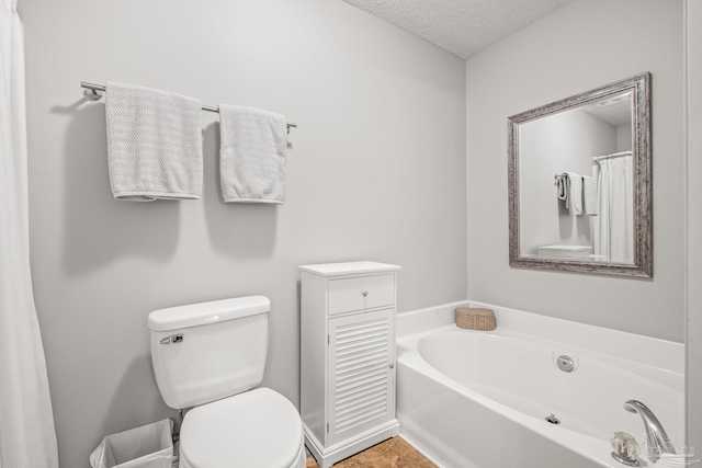 bathroom featuring separate shower and tub, a textured ceiling, and toilet