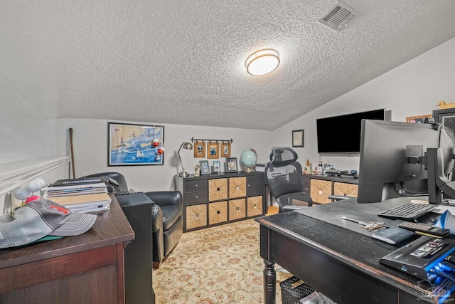 office area with a textured ceiling and lofted ceiling