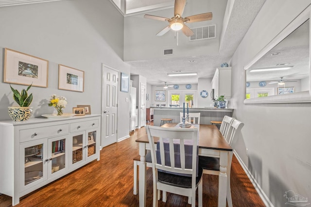 dining area featuring a textured ceiling and hardwood / wood-style floors