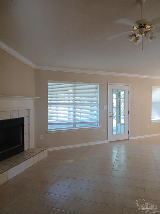 unfurnished living room featuring ceiling fan, light tile patterned flooring, ornamental molding, and a fireplace