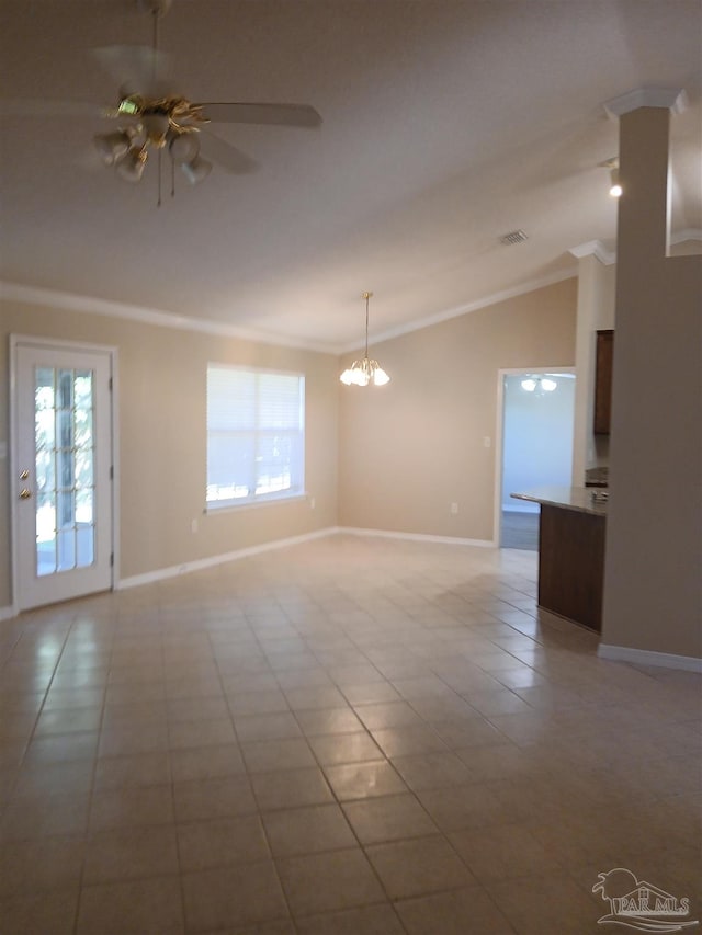 spare room with a wealth of natural light, light tile patterned flooring, ceiling fan with notable chandelier, and ornamental molding