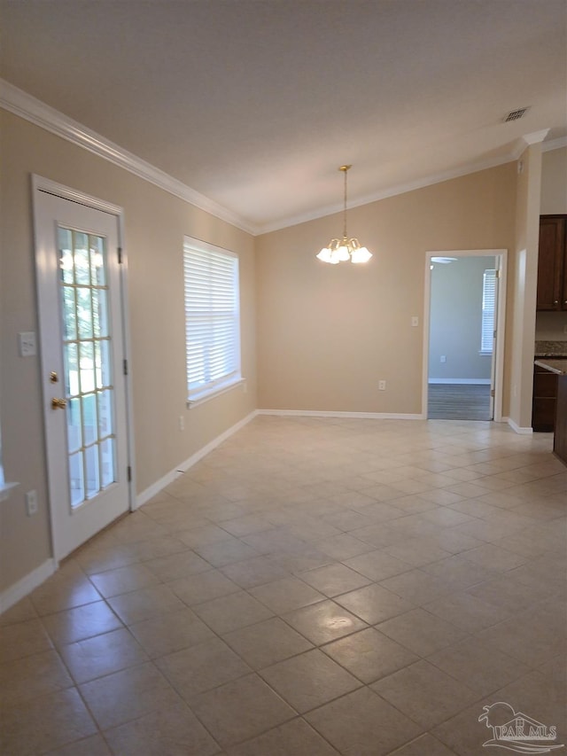 tiled spare room with crown molding and a chandelier