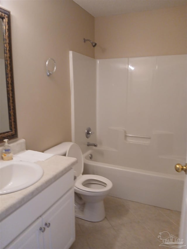 full bathroom with tile patterned floors, vanity, tub / shower combination, and toilet