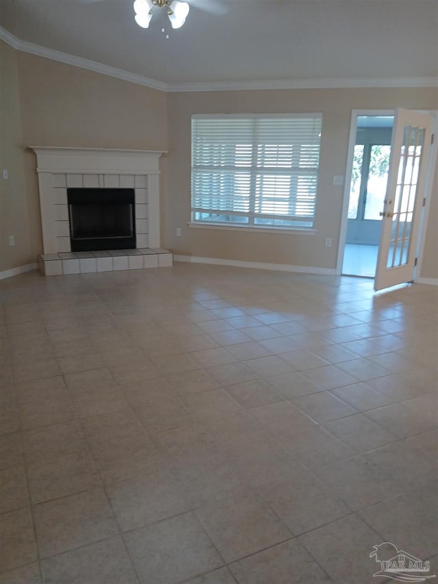 unfurnished living room featuring french doors, ceiling fan, crown molding, light tile patterned floors, and a fireplace