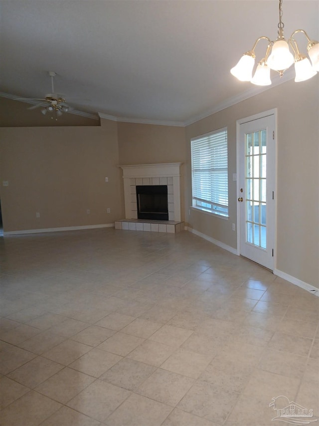 unfurnished living room featuring ceiling fan with notable chandelier, ornamental molding, and a tiled fireplace