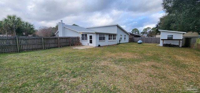 rear view of house with a yard