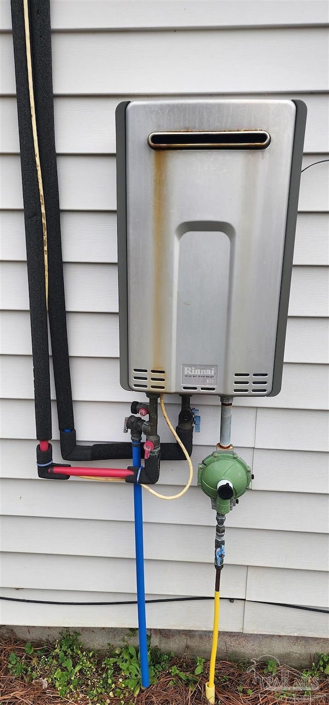 exterior details featuring tankless water heater