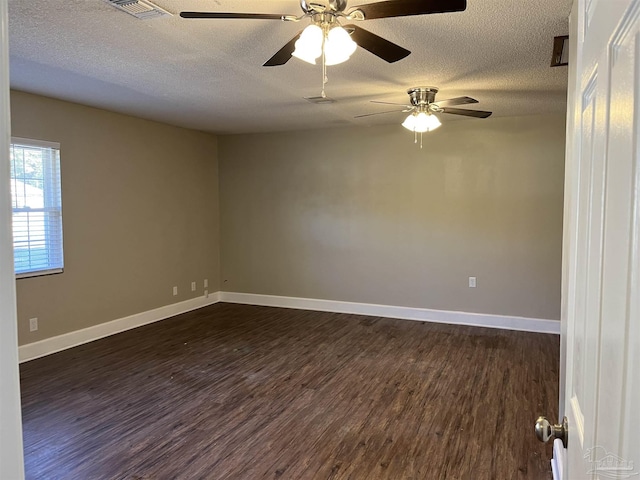 empty room featuring a textured ceiling, dark hardwood / wood-style flooring, and ceiling fan