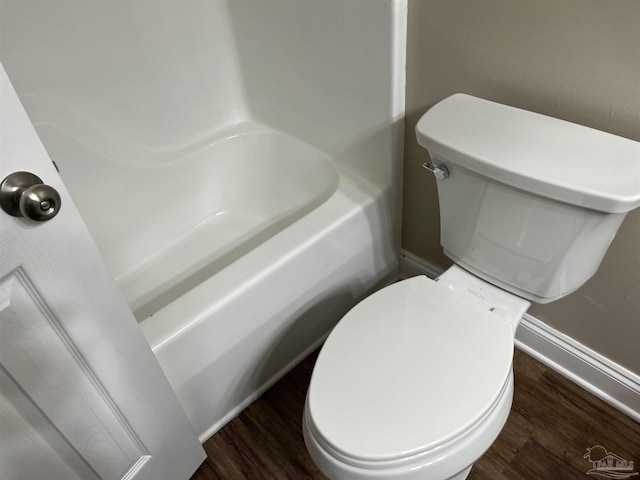 bathroom with hardwood / wood-style flooring and toilet