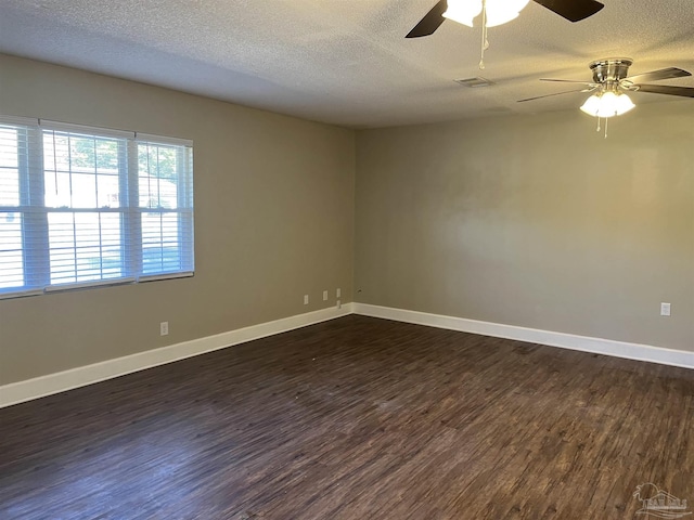 empty room with a textured ceiling, dark hardwood / wood-style flooring, and ceiling fan