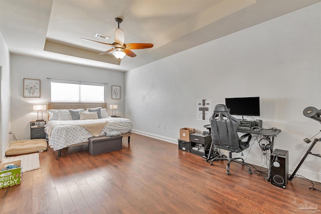 5811 Rustic Ridge Cir, Milton, FL 32570 - bedroom featuring a tray ceiling, hardwood / wood-style flooring, baseboards, a desk, and ceiling fan