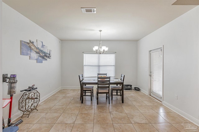 5811 Rustic Ridge Cir, Milton, FL 32570 - dining area featuring a chandelier, light tile patterned flooring, and baseboards