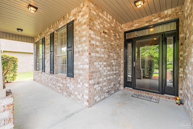 5811 Rustic Ridge Cir, Milton, FL 32570 - doorway to property featuring brick siding and covered porch
