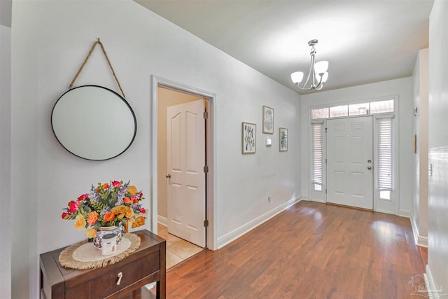 5811 Rustic Ridge Cir, Milton, FL 32570 - entrance foyer featuring a chandelier, wood finished floors, and baseboards