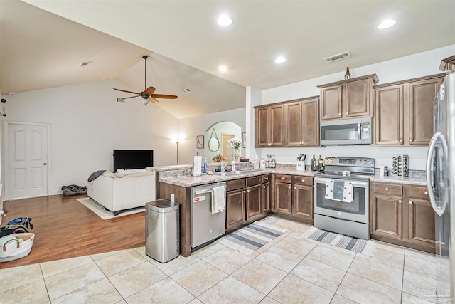 5811 Rustic Ridge Cir, Milton, FL 32570 - kitchen featuring appliances with stainless steel finishes, a ceiling fan, light tile patterned floors, open floor plan, and light stone countertops