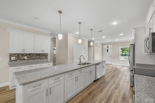 kitchen with white cabinets, stainless steel appliances, light wood-style flooring, a sink, and visible vents