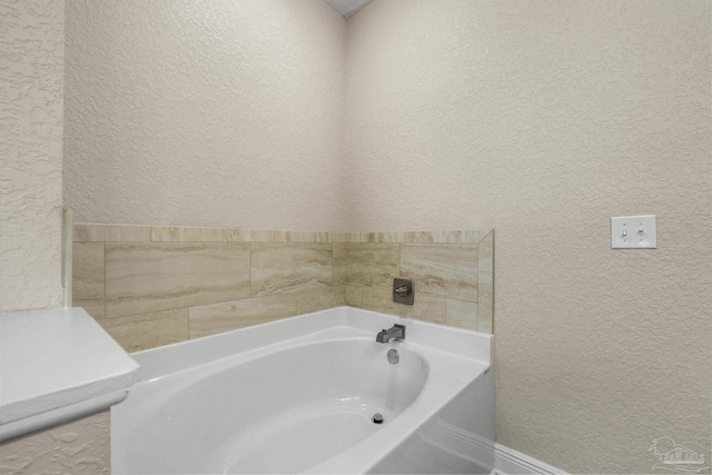 full bath with a bath and a textured wall