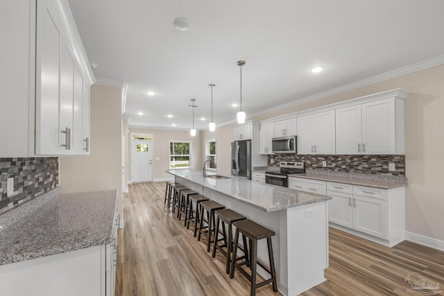 kitchen featuring white cabinets, appliances with stainless steel finishes, and a sink