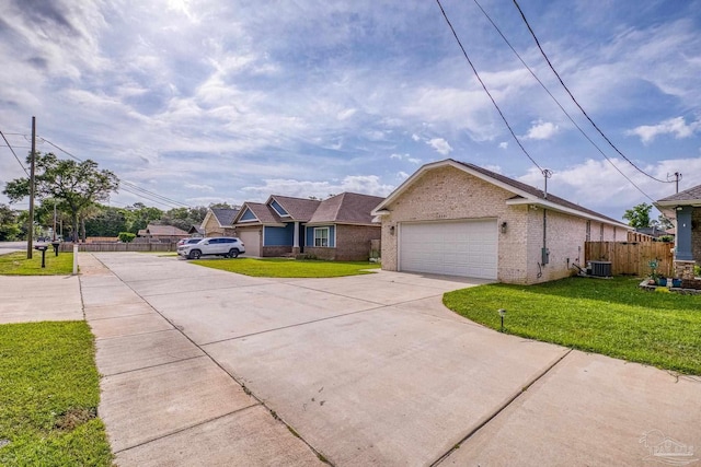 ranch-style home featuring fence, a front lawn, driveway, and central air condition unit