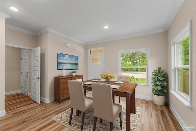 dining room featuring baseboards, ornamental molding, light wood finished floors, and recessed lighting