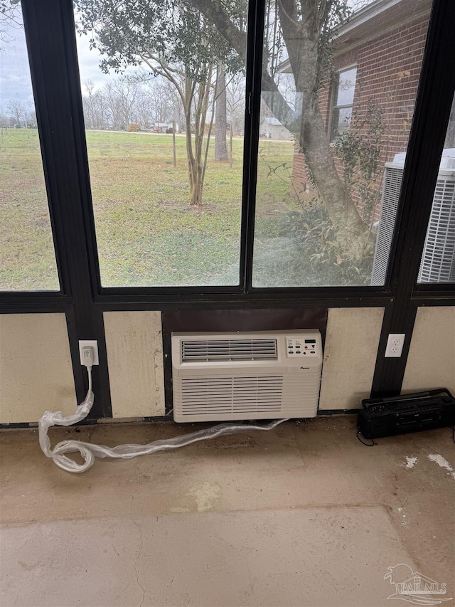 room details featuring a wall mounted AC and central air condition unit