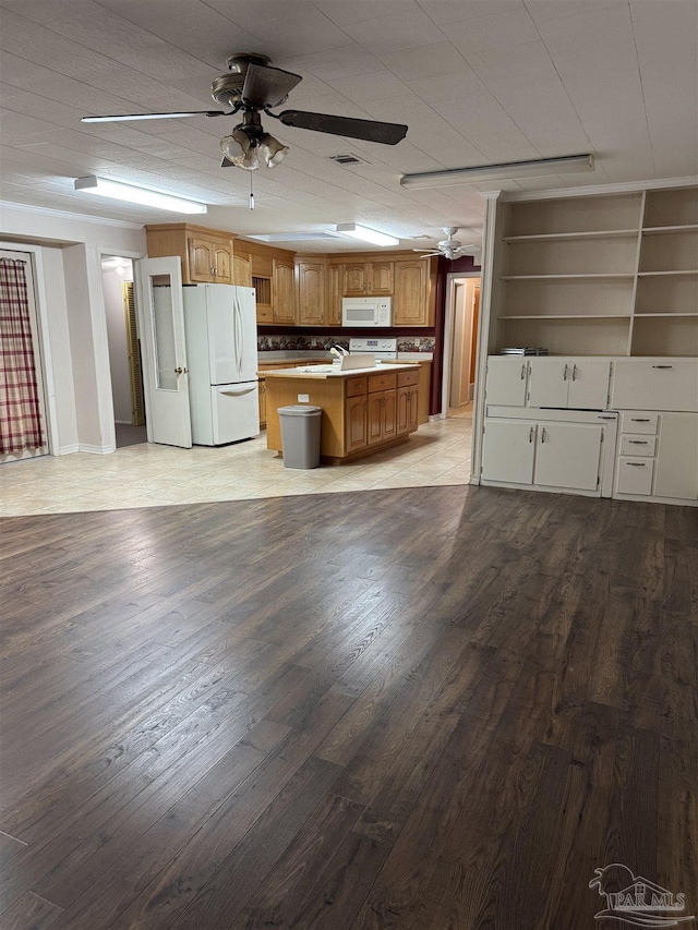 kitchen featuring ceiling fan, white appliances, a center island, and light hardwood / wood-style flooring