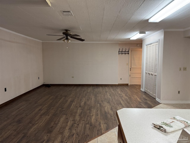 unfurnished room with crown molding, dark hardwood / wood-style floors, and ceiling fan