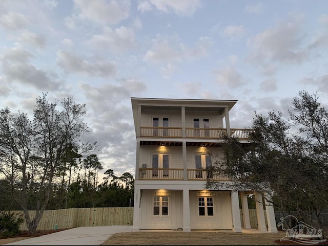 1557 Winding Shore Dr, Gulf Breeze, FL 32563 - view of front facade with a balcony, french doors, and driveway