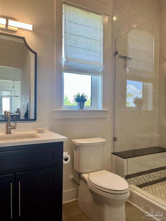 1557 Winding Shore Dr, Gulf Breeze, FL 32563 - full bath featuring a shower stall, toilet, vanity, and baseboards
