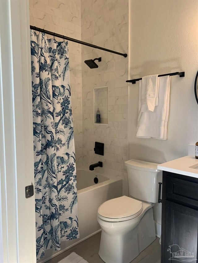 1557 Winding Shore Dr, Gulf Breeze, FL 32563 - bathroom featuring toilet, vanity, and shower / bath combo with shower curtain