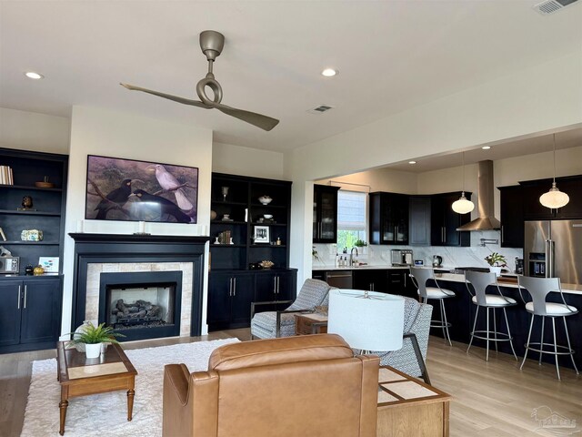 1557 Winding Shore Dr, Gulf Breeze, FL 32563 - living room with ceiling fan, light wood finished floors, recessed lighting, and a fireplace