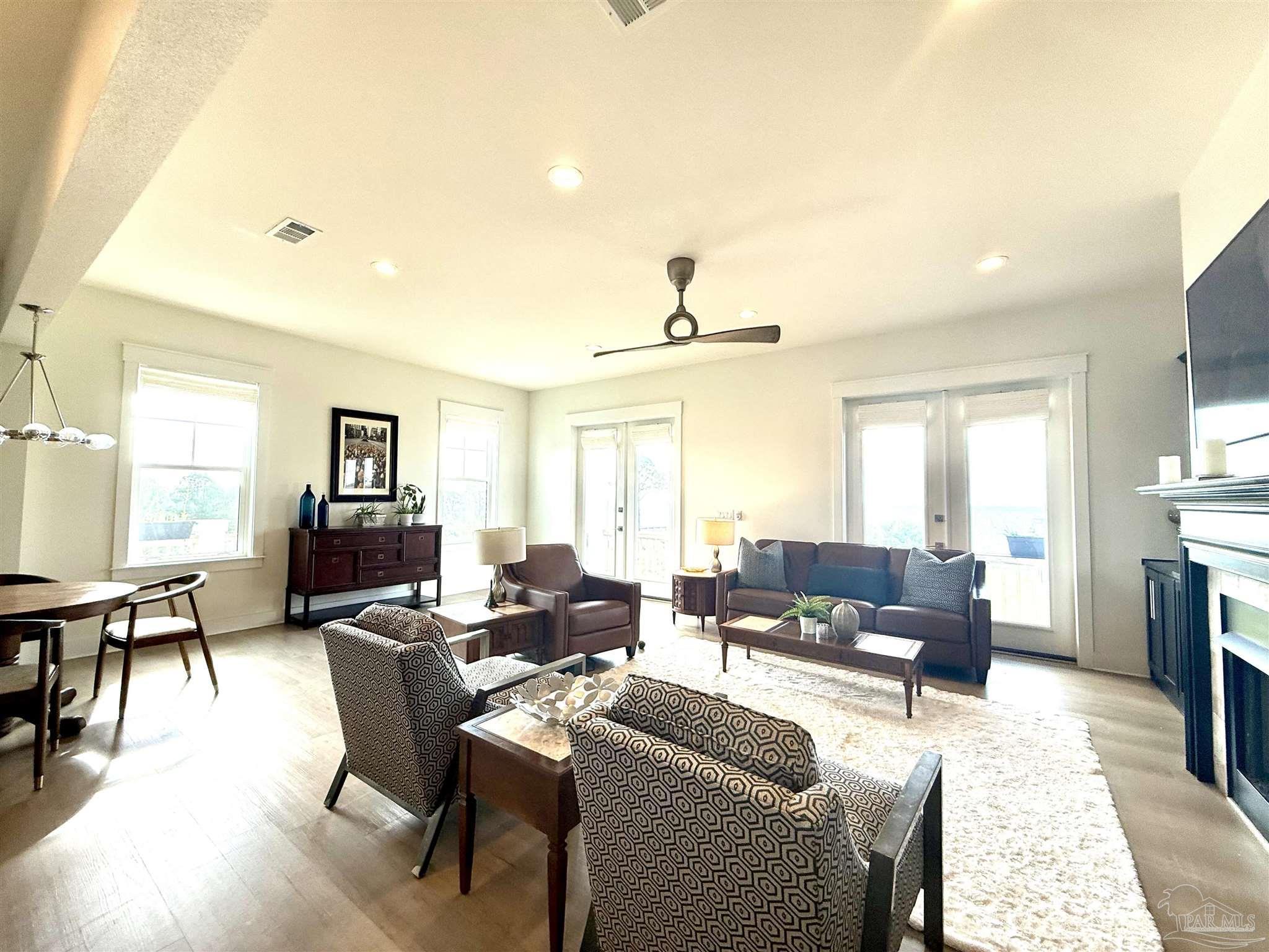 1557 Winding Shore Dr, Gulf Breeze, FL 32563 - living area featuring healthy amount of natural light, recessed lighting, a fireplace with flush hearth, and light wood-type flooring