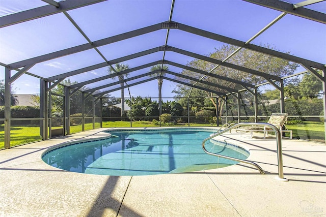 view of swimming pool with a lawn, glass enclosure, and a patio area