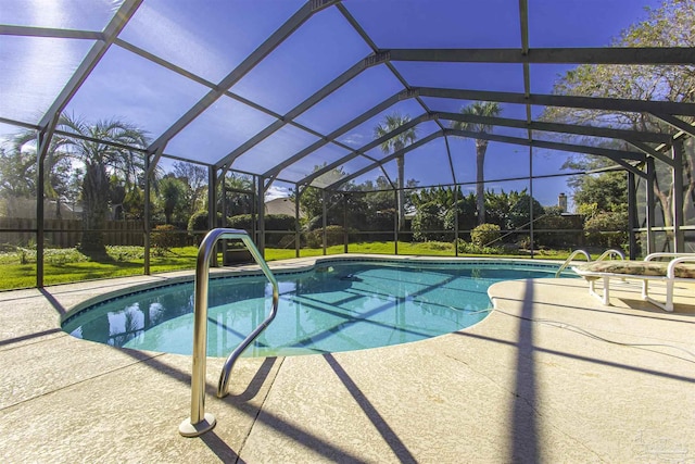 view of swimming pool with a yard, a patio, and glass enclosure