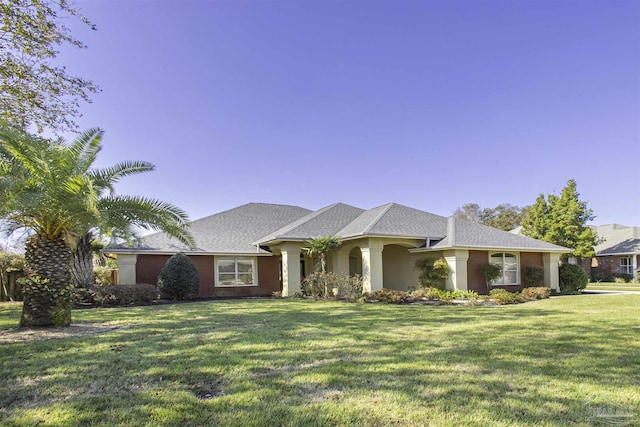 single story home featuring a front lawn