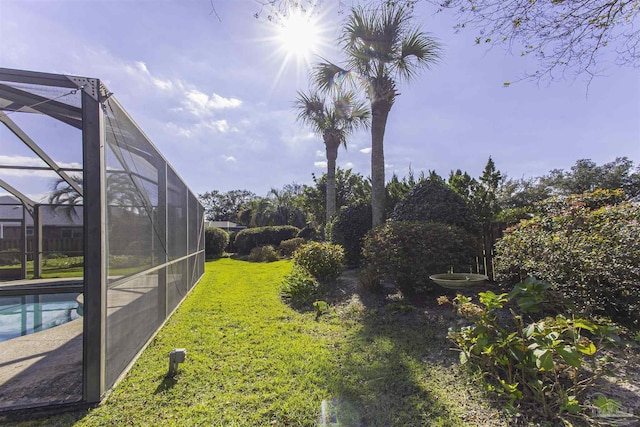 view of yard featuring glass enclosure