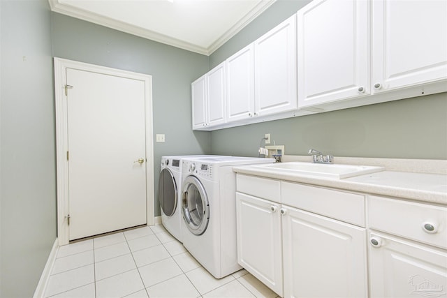 laundry area with sink, crown molding, cabinets, light tile patterned floors, and washing machine and dryer