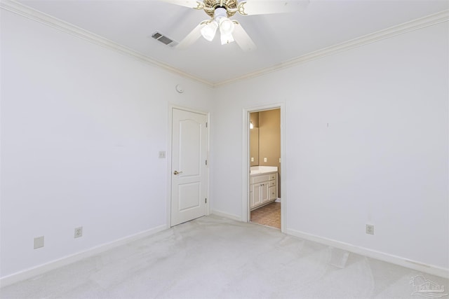 carpeted spare room featuring ornamental molding and ceiling fan