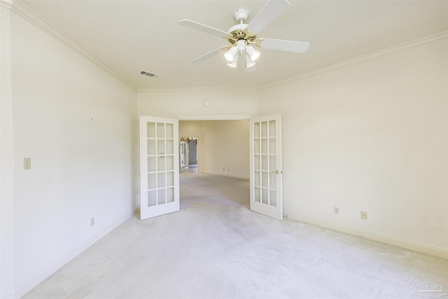 unfurnished room featuring light carpet, crown molding, and french doors